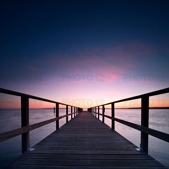 Long jetty at the lake at sunrise