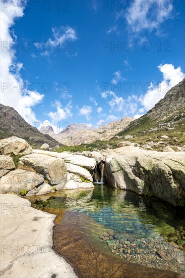 Pool with small waterfall in the mountains