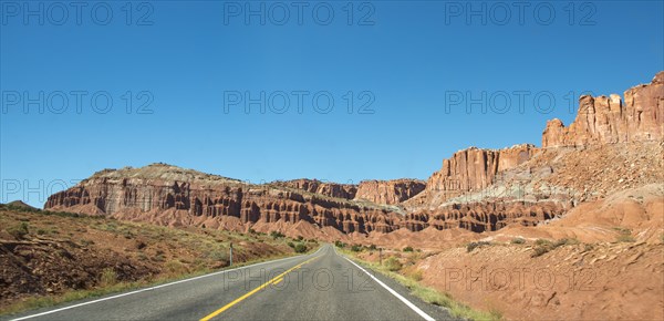 Red rugged sandstone cliffs on Highway 24