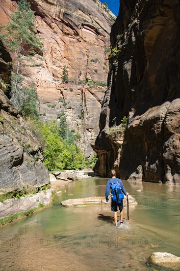 Hiker walks in the water