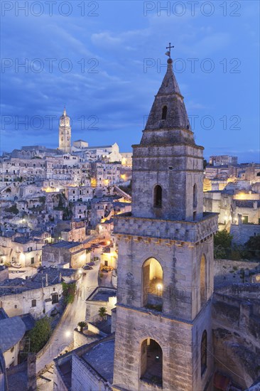 View of Church of San Pietro Barisano and Sasso Barisano historic centre with cathedral at dusk