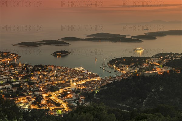Town view Hvar with harbour and Pakleni islands at sunset