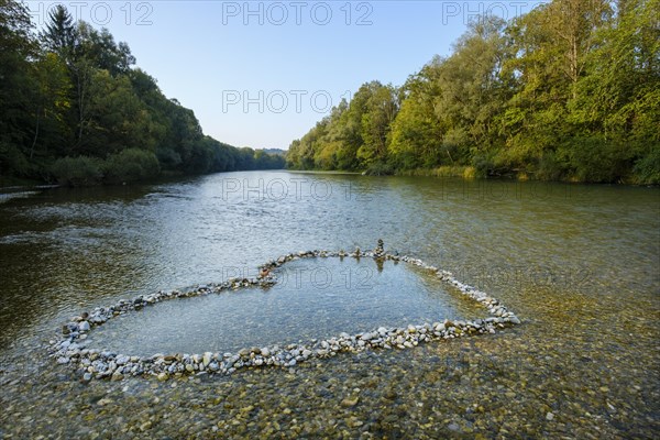 Heart-shaped piles of Isar pebbles in the shallow riverbed