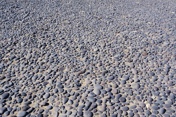 Round black pebbles on the beach