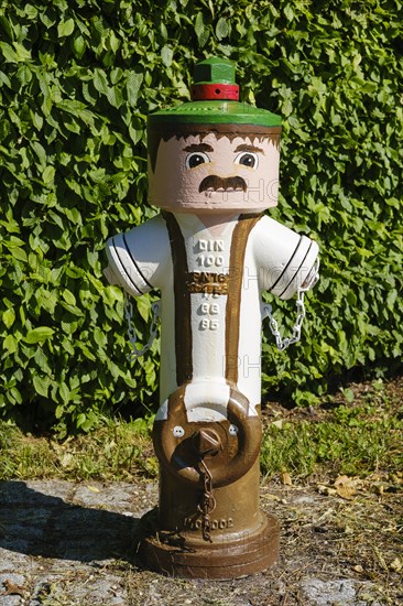 Painted hydrant in Bavarian traditional costume