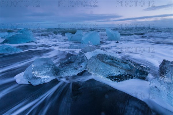 Ice chunks on a black sandy beach