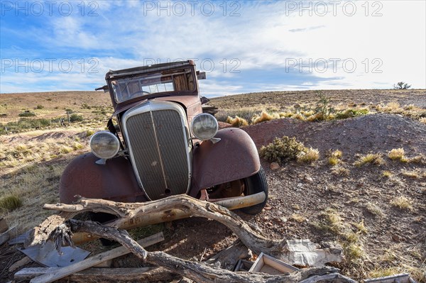 Pampa with old car on a farm in Bosques Petrificados de Jaramillo National Park