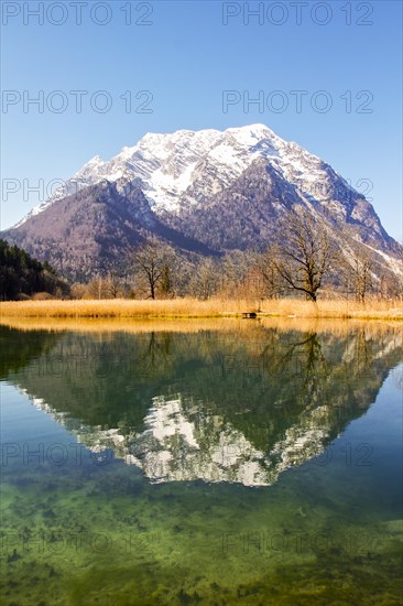 Grimming mountain reflected in the lake in spring