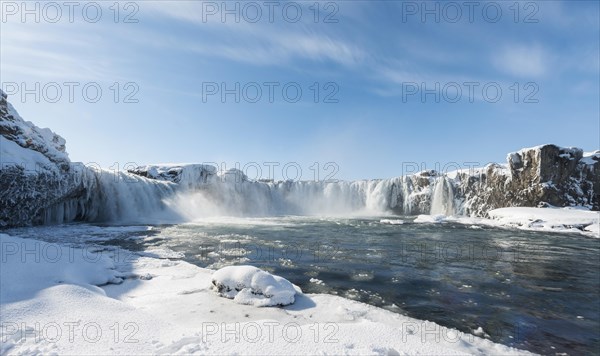 Gooafoss Waterfall in winter with snow and ice