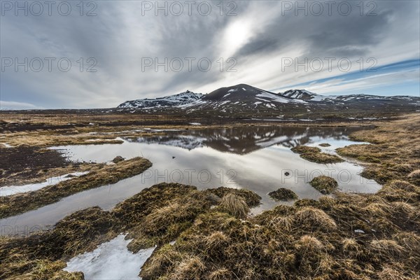 Hills reflected in snow melt