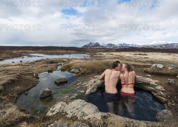 Young couple kissing in hot spring