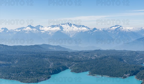 Garibaldi Lake in front of mountain range with snow and glacier