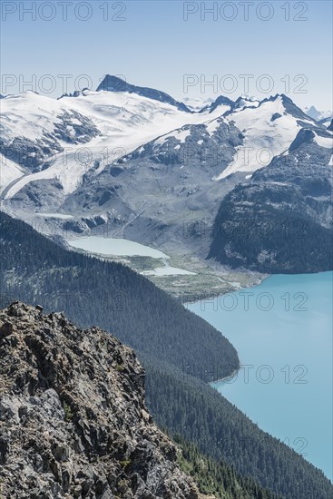 Turquoise Glacial Lake Garibaldi Lake in front of mountain range with snow and glacier