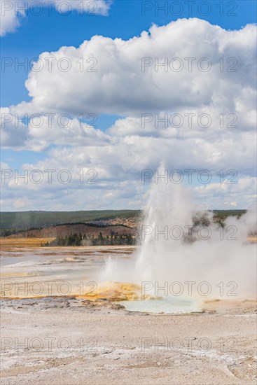 Steaming geyser with water fountain