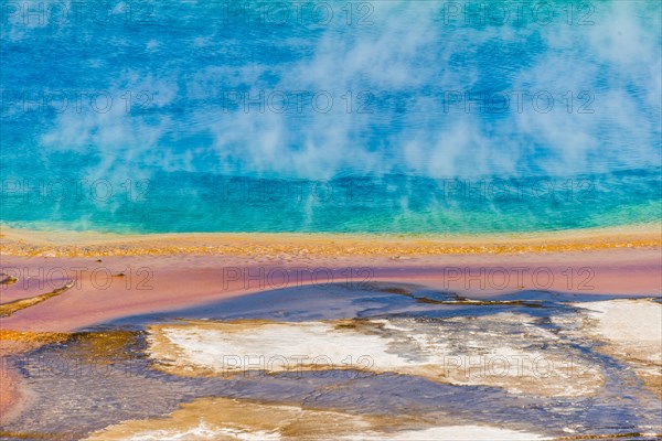 Colored mineral deposits at the edge sr steaming hot spring