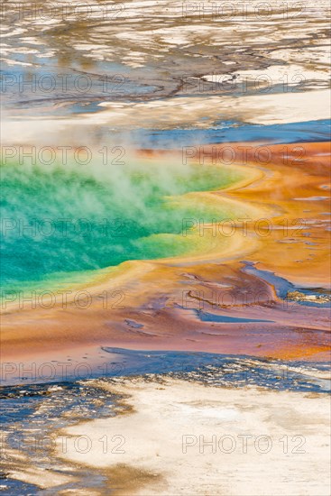 Colored mineral deposits at the edge sr steaming hot spring