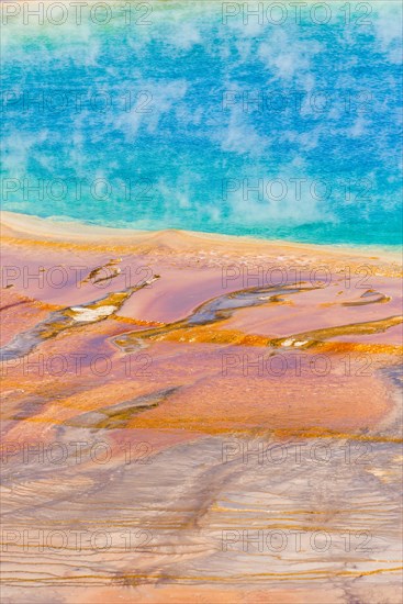 Colored mineral deposits at the edge sr steaming hot spring