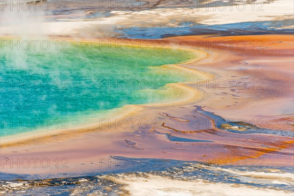 Colored mineral deposits at the edge sr steaming hot spring