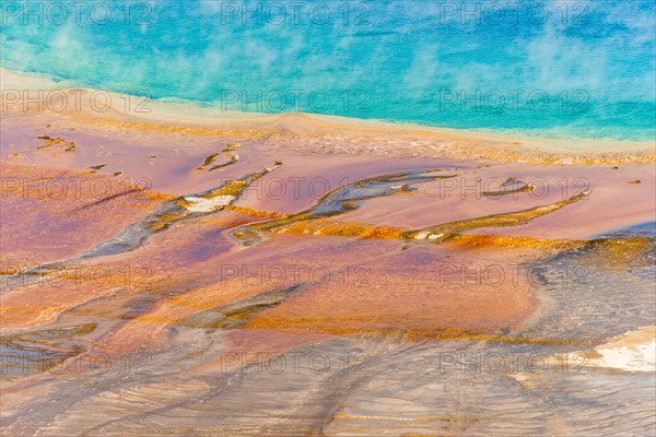 Colored mineral deposits at the edge sr steaming hot spring