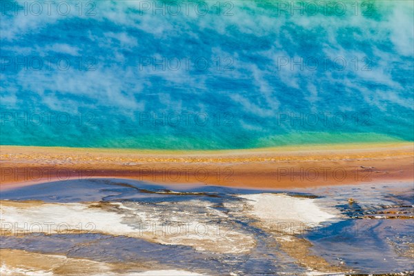 Colored mineral deposits at the edge sr steaming hot spring