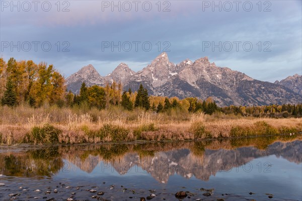 Grand Teton Range mountain range reflected in the river