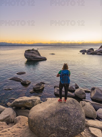 Young woman standing on the shore of Lake Tahoe