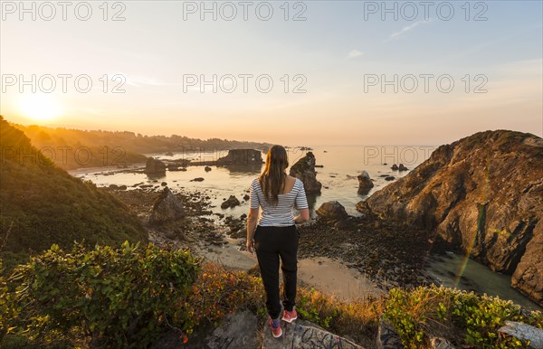 Young woman looking into the sunrise