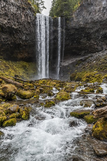 Waterfall plunges over rocky outcrop