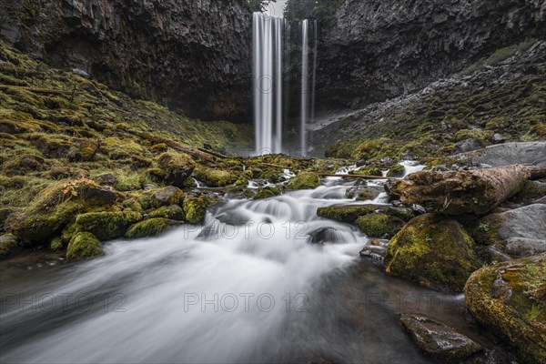Waterfall plunges over rocky outcrop