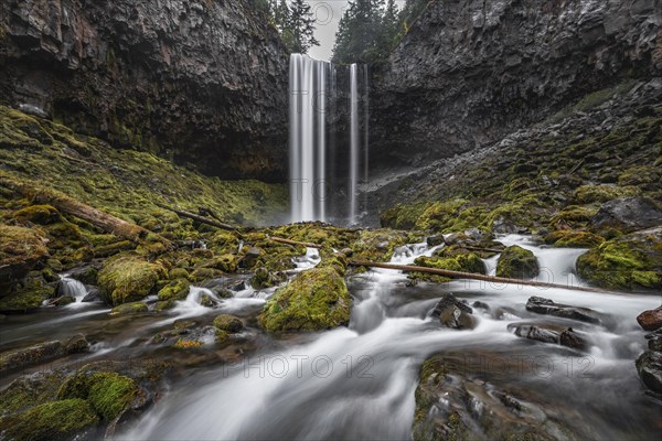 Waterfall plunges over rocky outcrop