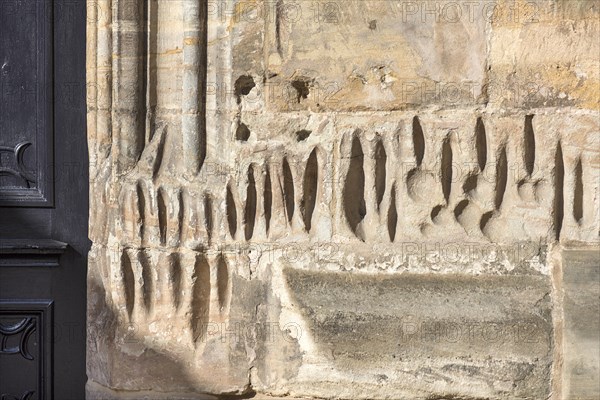 Medieval sharpening grooves on a church wall