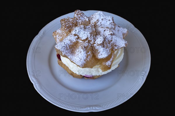 Cream puff on a white plate