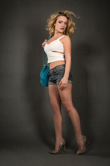 Young woman in hotpants and bag