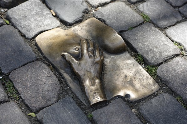 Bronze relief in cobblestone