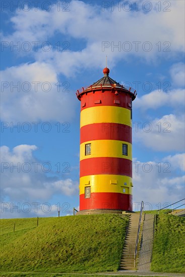 Pilsum lighthouse with blue cloudy sky