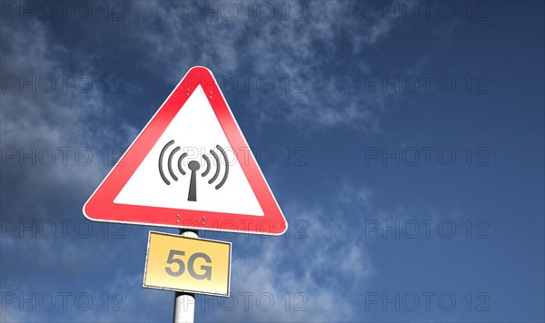 Warning sign against blue sky with clouds