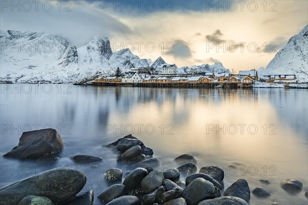 Town and fisherman's cabins or Rorbus in front of snowy mountains