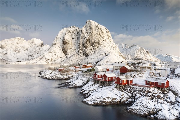 Town and fisherman's cabins or Rorbus in front of snowy mountains