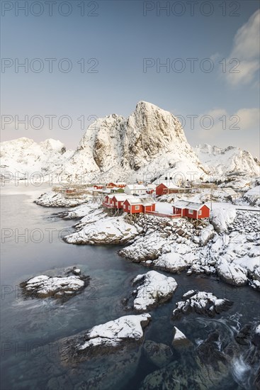 Town and fisherman's cabins or Rorbus in front of snowy mountains