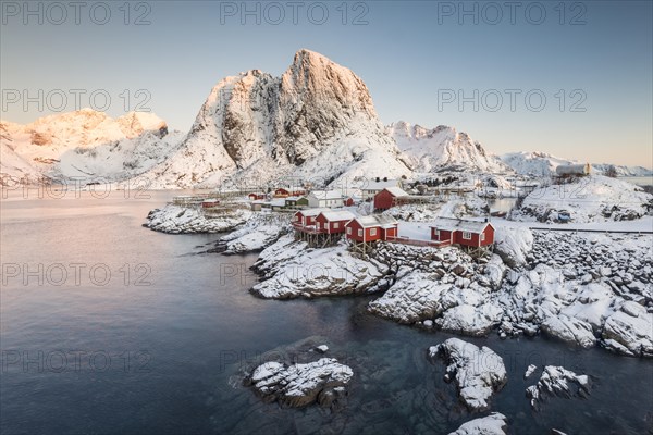 Town and fisherman's cabins or Rorbus in front of snowy mountains