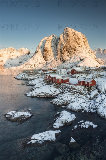 Town and fisherman's cabins or Rorbus in front of snowy mountains