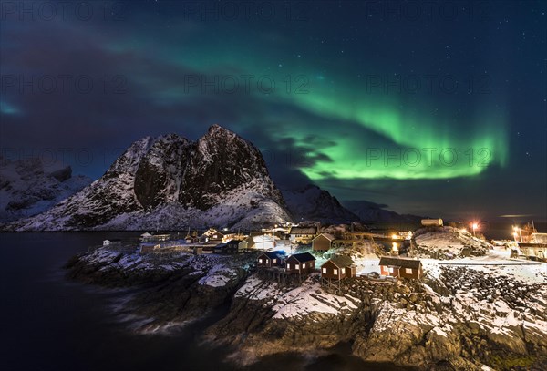 Town and fisherman's cabins or Rorbus in front of snowy mountains