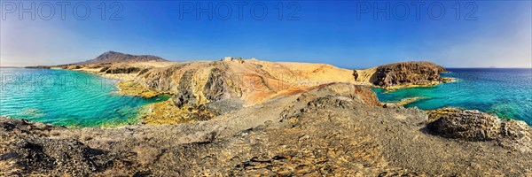 Rocky coastline and sandy beach with turquoise waters of Playa del Papagayo