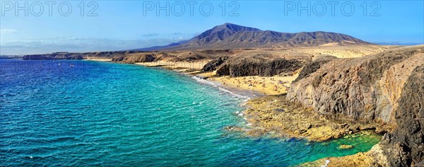 Sandy beach and rocky coastline with turquoise waters of Playa del Papagayo