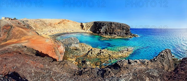 Sandy beach and rocky coastline with turquoise waters of Playa del Papagayo