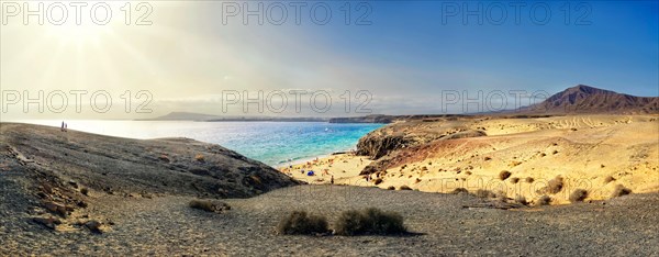 Sandy beach and rocky coastline with turquoise waters of Playa del Papagayo