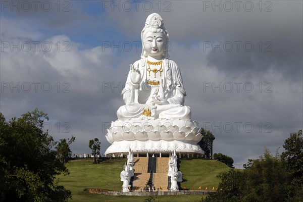 Giant Guan Yin statue sitting on lotus flower