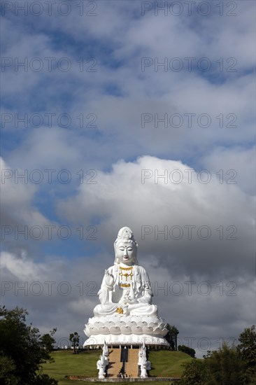 Giant Guan Yin statue sitting on lotus flower