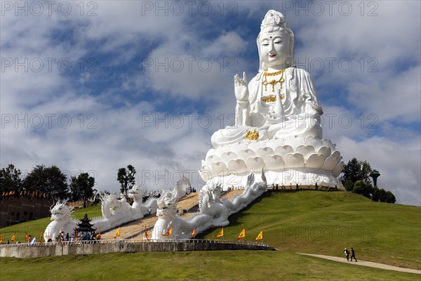 Giant Guan Yin statue sitting on lotus flower