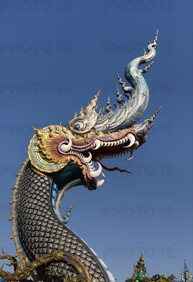 Richly decorated Naga at the entrance of Wat Rong Seur Ten